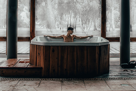man relaxing in hot tub